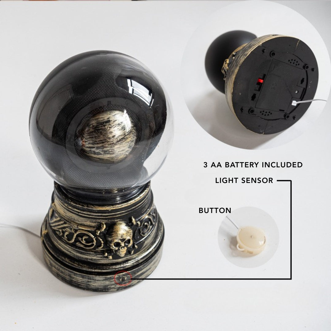 Decorative lamp with skull design, featuring a light sensor and battery compartment on a white background.