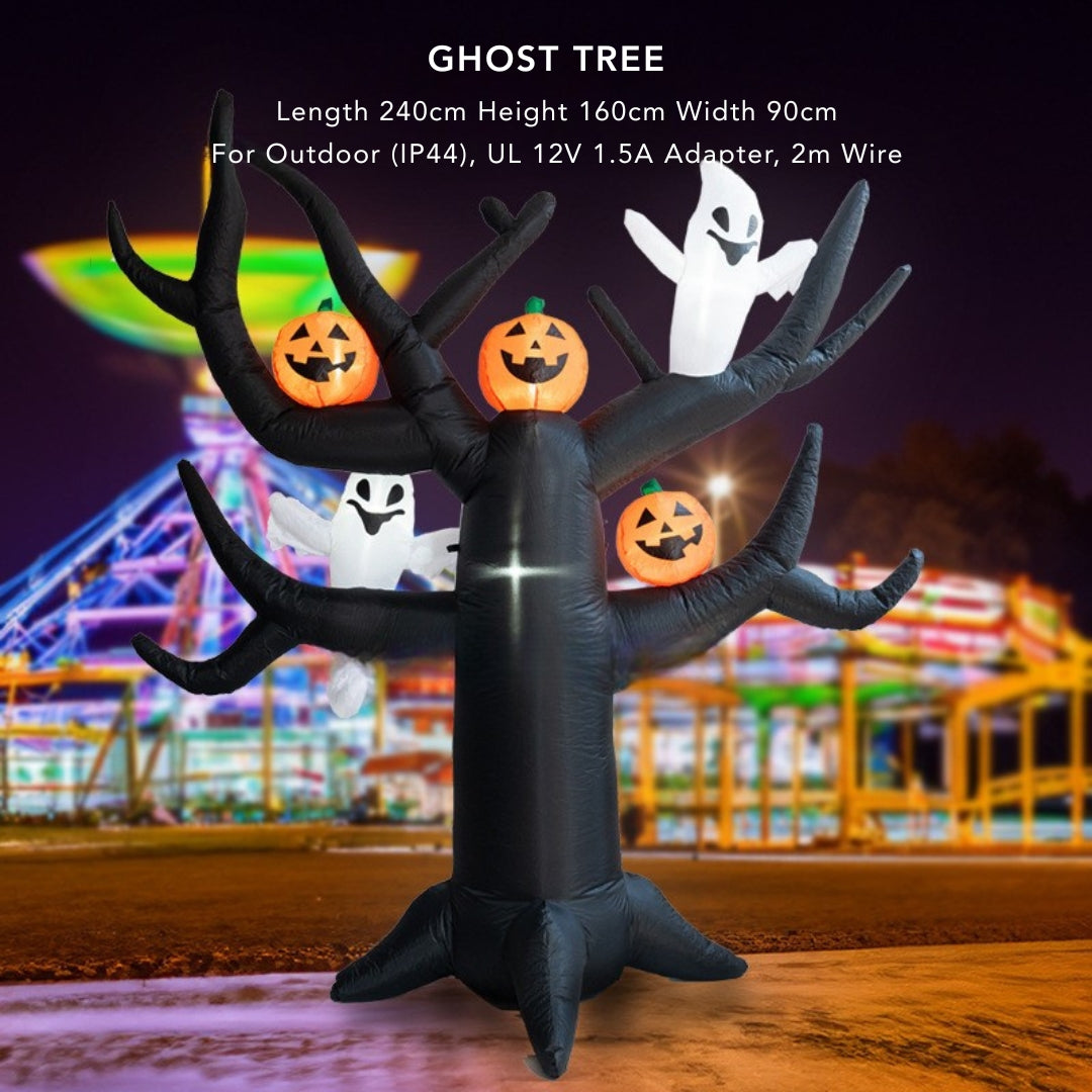 Inflatable ghost tree with pumpkins and ghosts against a night-time amusement park background.