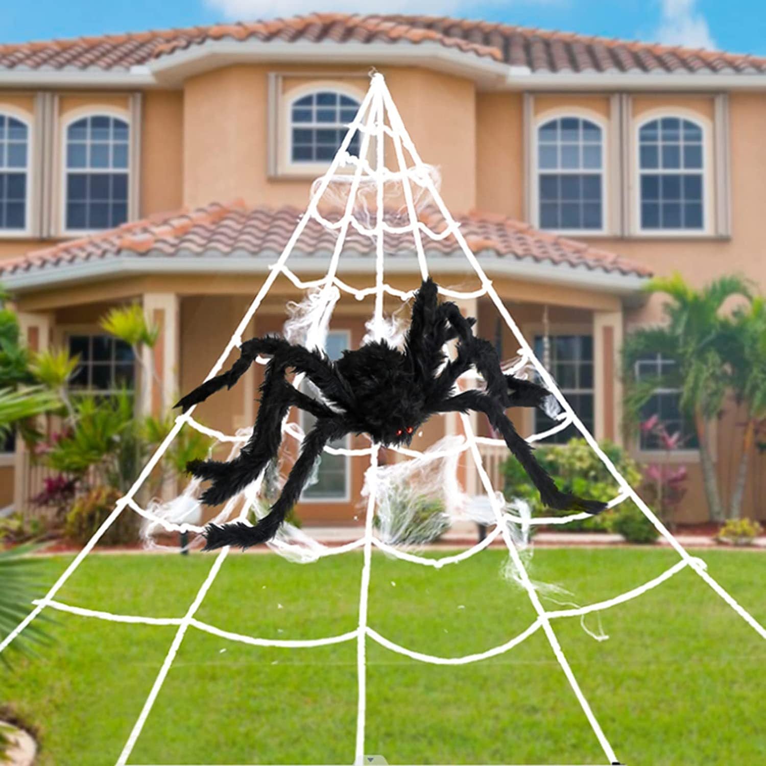 Large spider and spider web decoration in front of a house