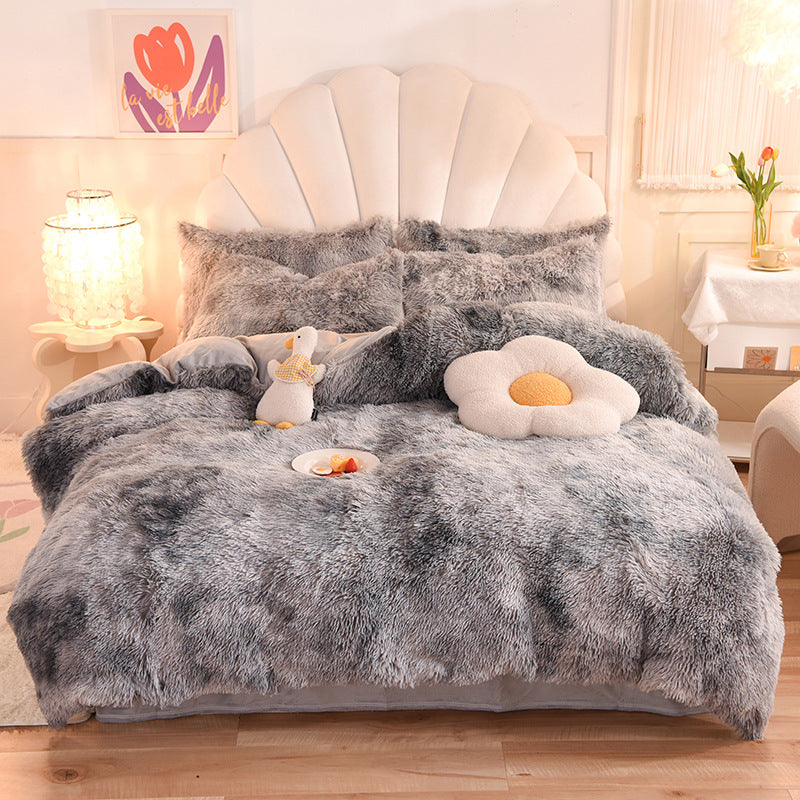 Gray fluffy comforter set on a bed 