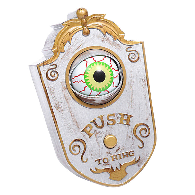 Decorative doorbell with eye design and 'Push to Ring' text on a white background