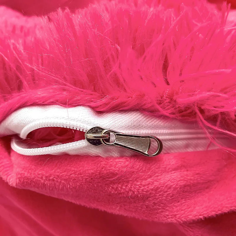 Close-up of a pink fluffy fabric with a white zipper