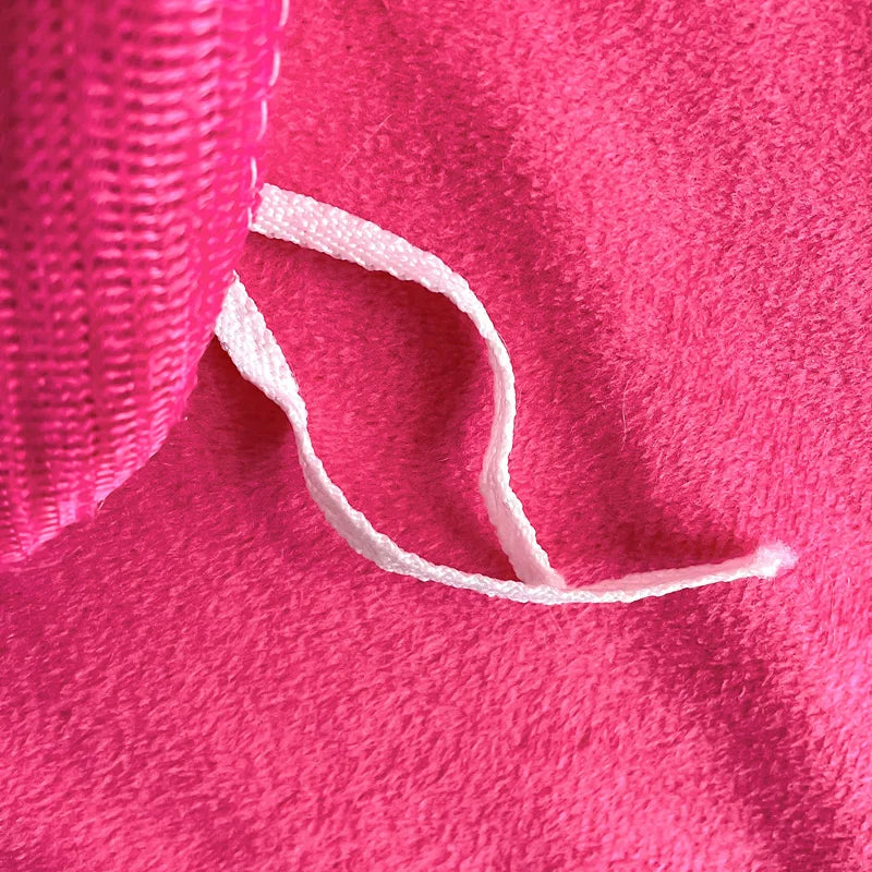 Close-up of pink fabric with a white elastic band