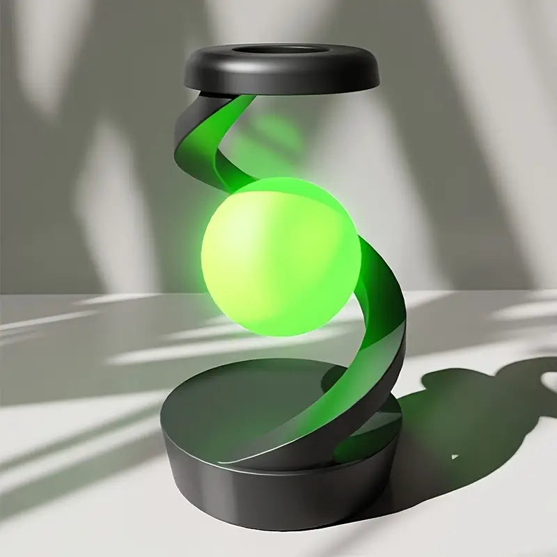 Green levitating sphere with black base on a white surface